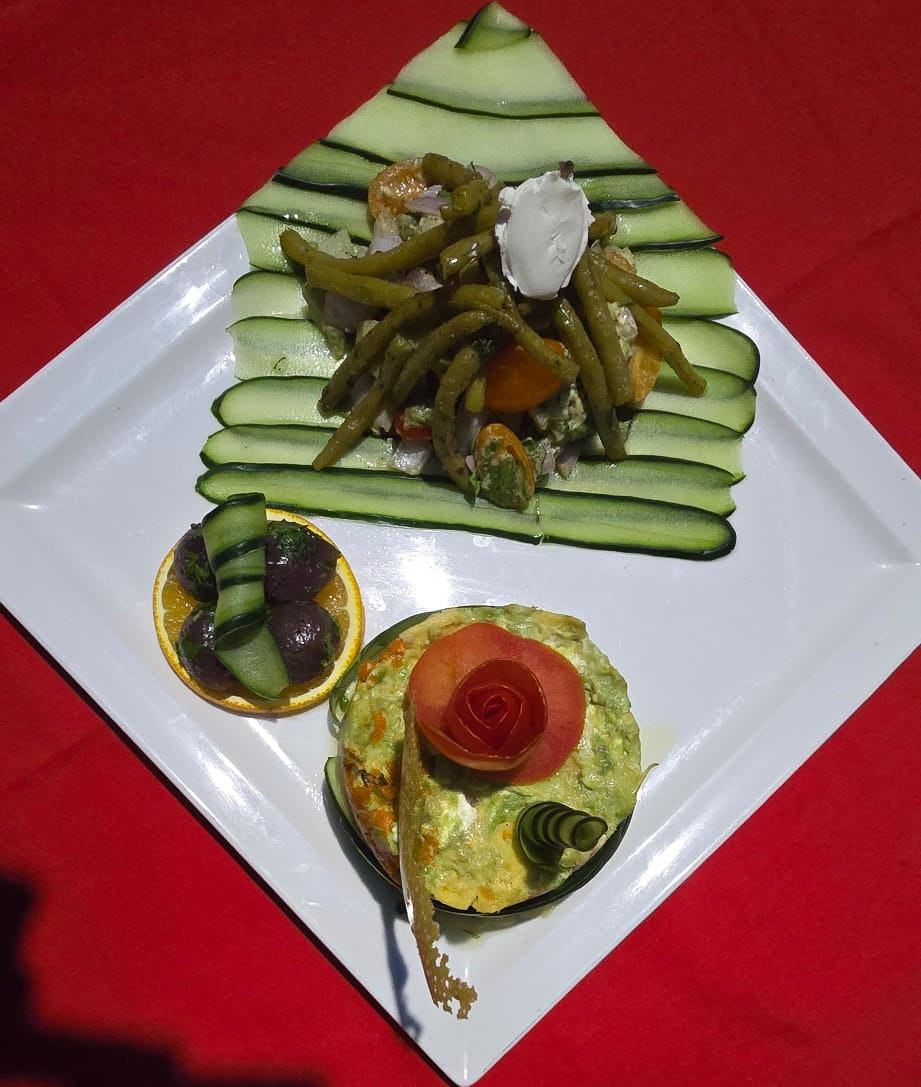 Moroccan green bean salad plated with a hand-carved tomato rose and cucumber fan