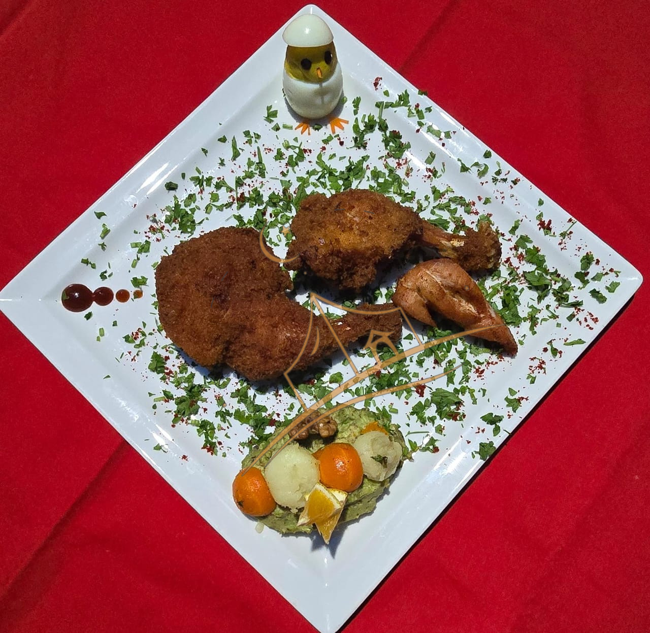 Crispy fried chicken pieces dusted with herbs on a bold red tablecloth