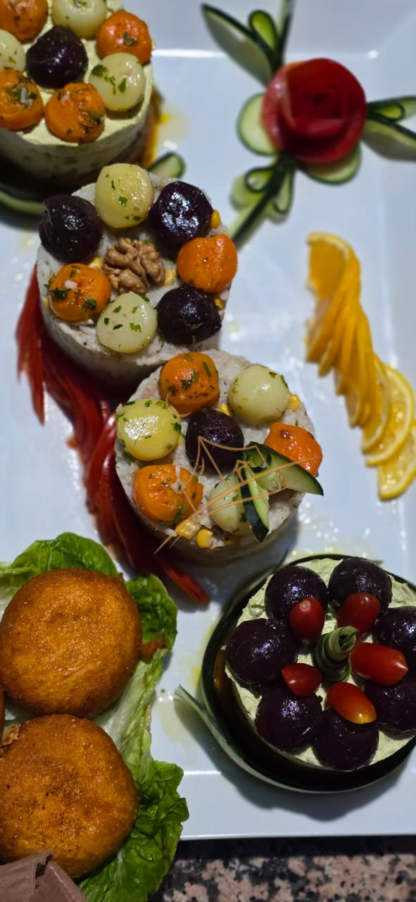 Vegetable and rice timbales topped with glazed baby carrots and beets beside crispy croquettes