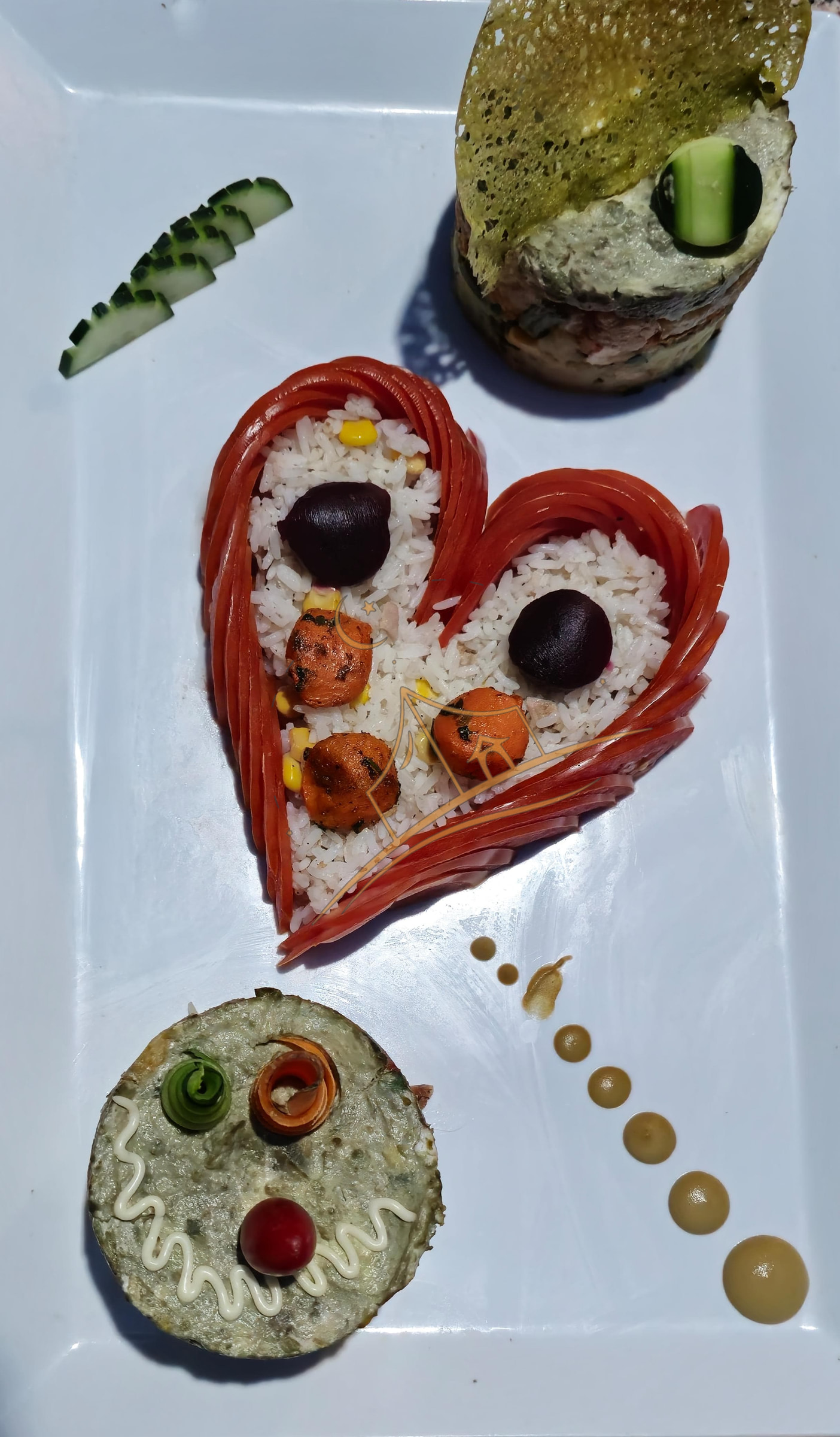 Heart-shaped rice presentation garnished with olives and roasted carrots