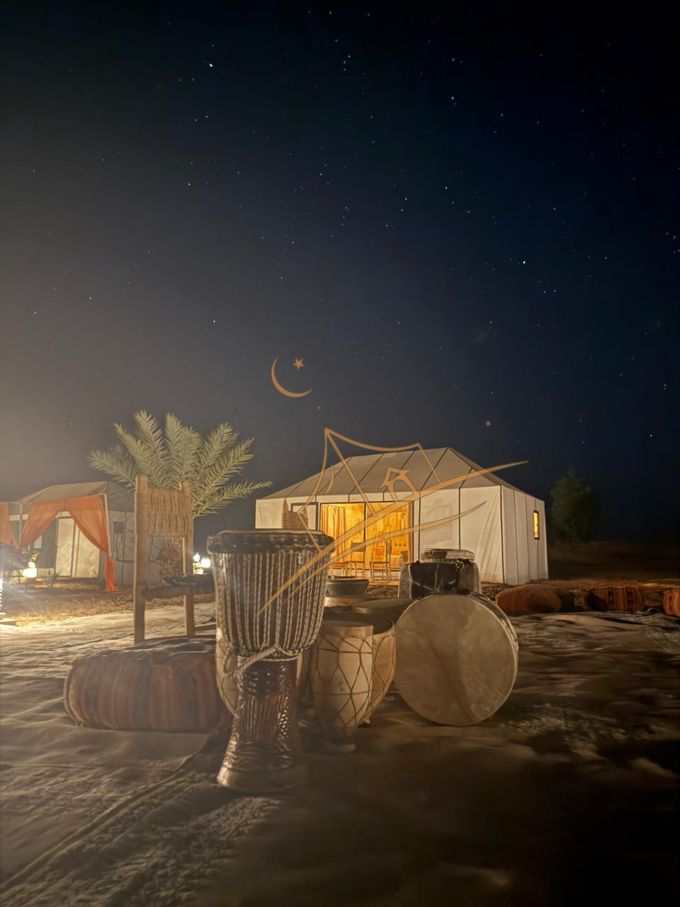 Berber drums set beneath a star-filled desert sky beside a glowing tent